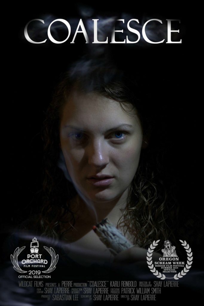 Promotional poster for 'Coalesce': A captivating figure emerges from shadows, her gaze piercing through darkness to connect with the viewer. Wisps of sage smoke swirl around her, unveiling the title 'Coalesce' from above, signaling the beginning of an immersive journey. Below, two laurels proudly announce acclaim, promising an unforgettable cinematic experience.